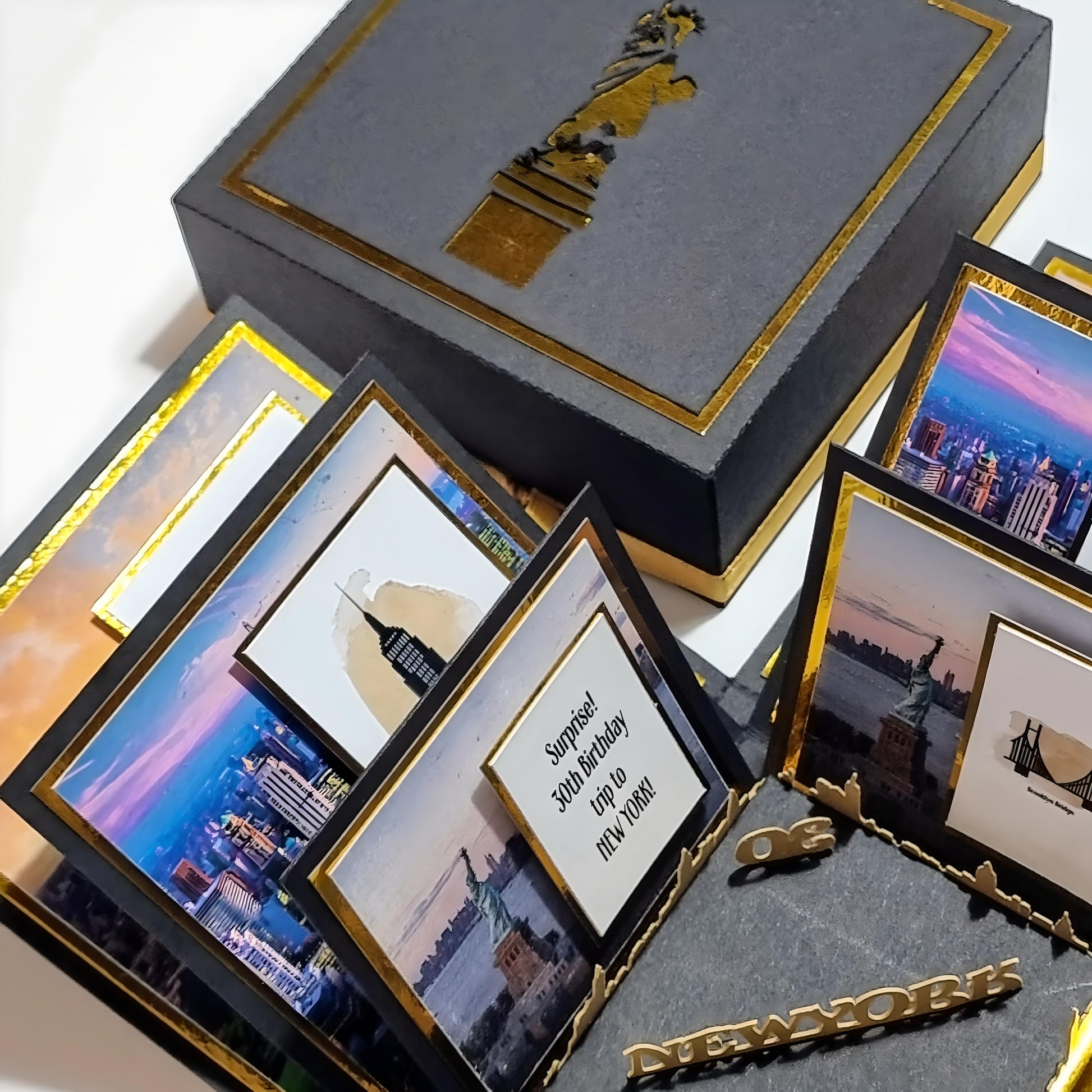 New York - Black & Gold - Surprise Special Occasion | Celebration Trip Reveal Explosion Box featuring iconic New York architecture, including a freestanding Statue of Liberty, within an intricately designed box.