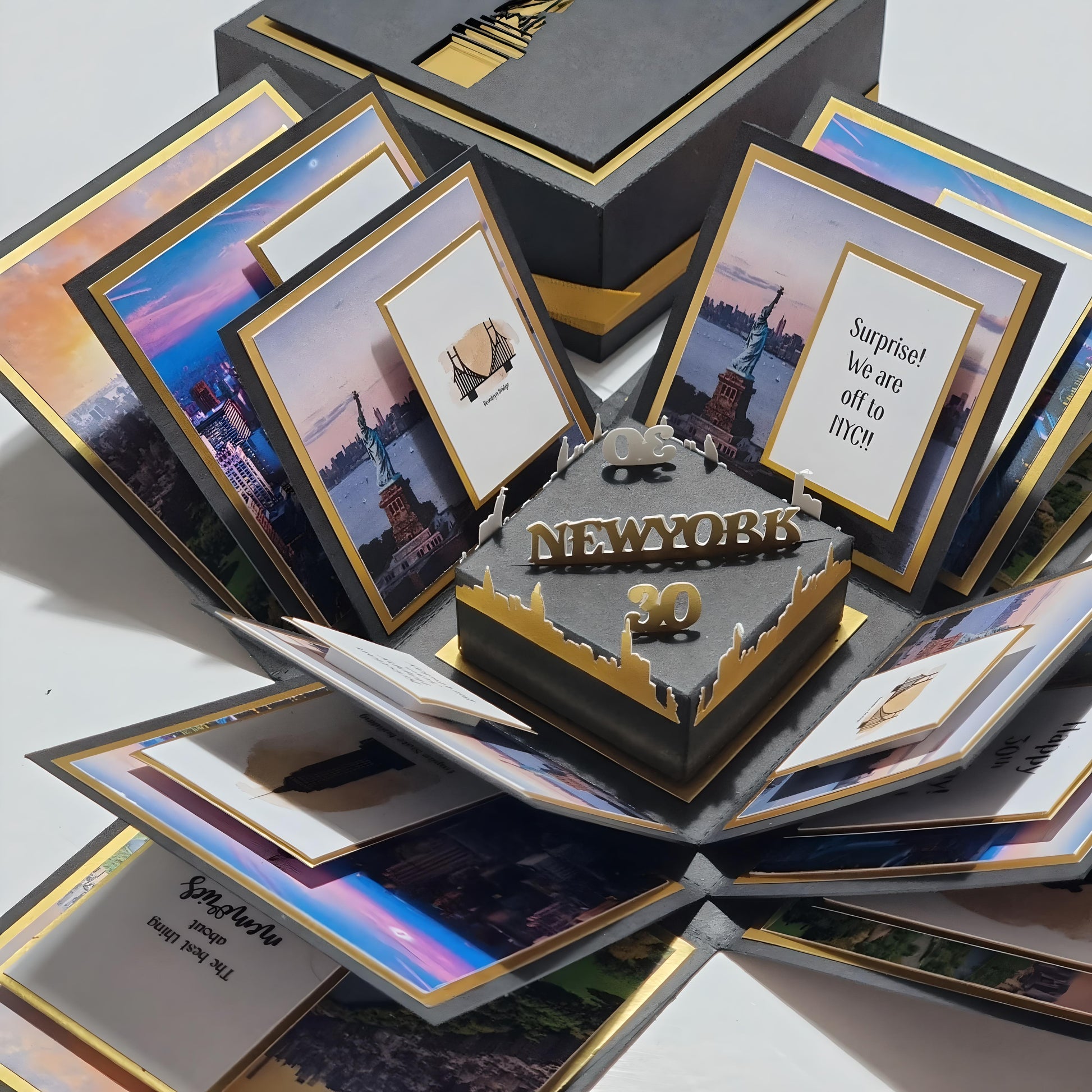 New York - Black & Gold - Surprise Special Occasion | Celebration Trip Reveal Explosion Box featuring iconic New York skyline, Statue of Liberty centerpiece, and themed paper panels inside a decorative box.