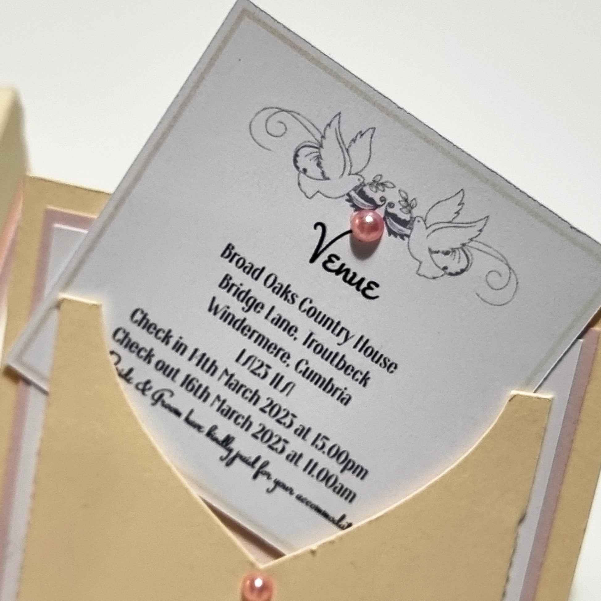 Bohemian Bespoke Exploding Wedding Invitations featuring a cartoon bird design, nestled in an envelope, with intricate wedding-themed elements like a central three-tier cake and two waistcoat-styled pockets for inserts.