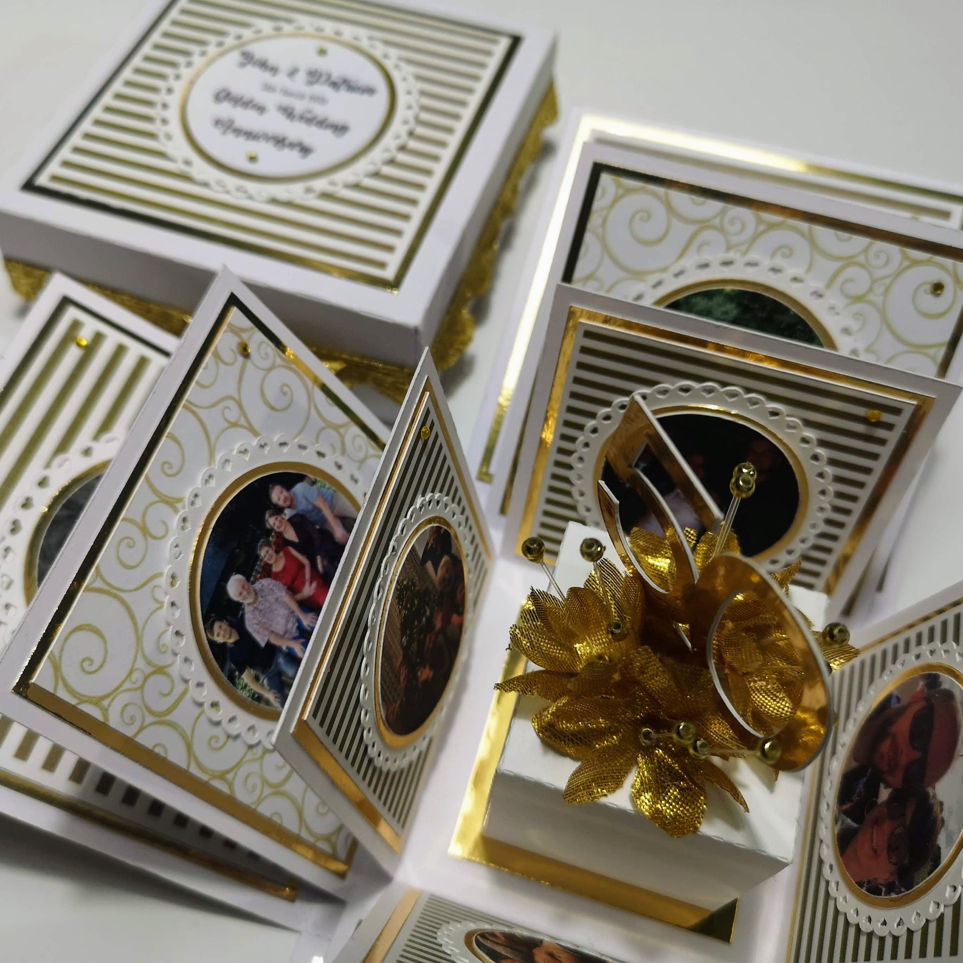 Golden Wedding Anniversary Exploding Box, a white and gold keepsake with intricate gold designs, featuring customizable panels for photos and messages, celebrating fifty years of love and commitment.