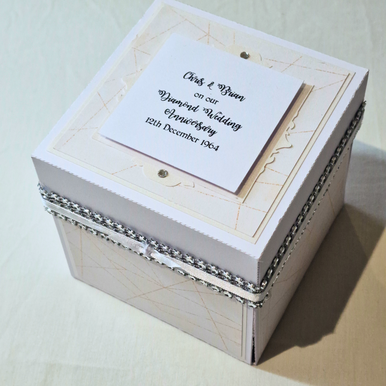 Diamond Wedding Anniversary Exploding Box featuring a white box with an elegant card atop, accented with diamantes, perfect as a 60th Anniversary keepsake gift.