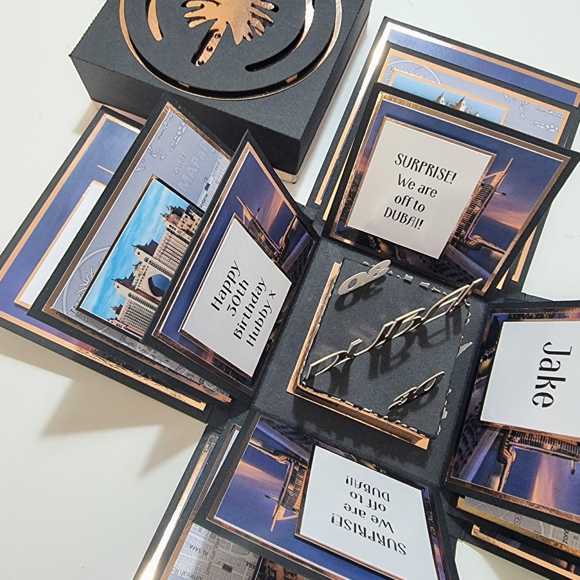 Exploding Occasions Box - Trip Reveal Dubai featuring Dubai-themed panels, freestanding Dubai centerpiece, and personalized text elements for a special surprise trip announcement.