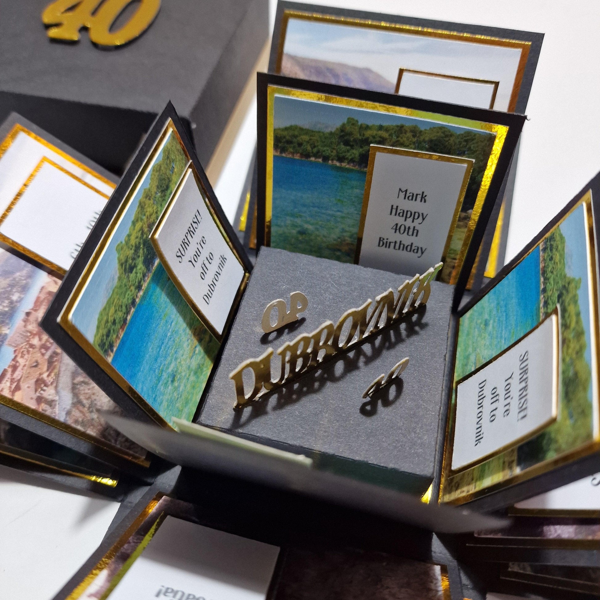 Exploding Trip Reveal Box - DUBROVNIK featuring intricate paper panels, New York-themed elements like the Statue of Liberty, and landscape designs, designed for a unique surprise trip announcement.