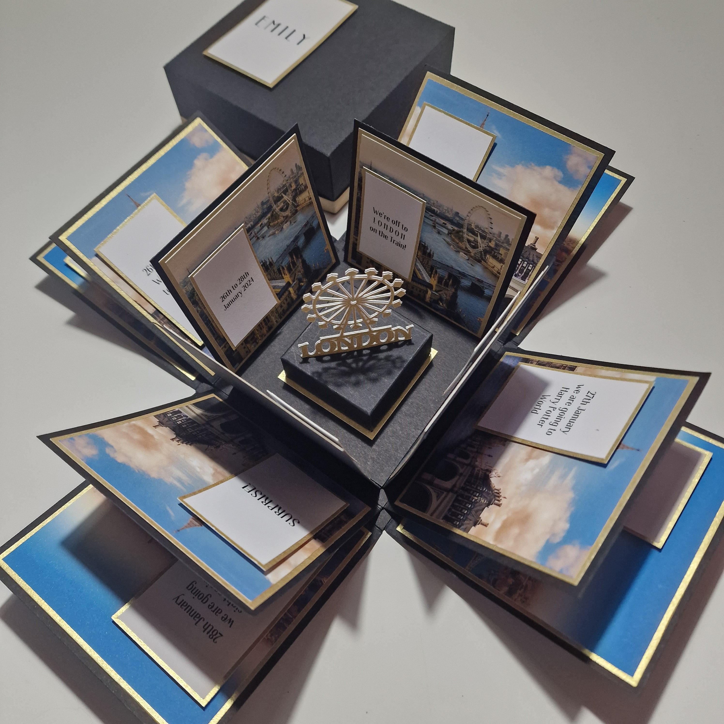 Exploding Occasions Box - Trip Reveal LONDON, featuring a detailed London-themed surprise box with a freestanding London Eye statuette and iconic architectural panels, designed for special trip announcements.