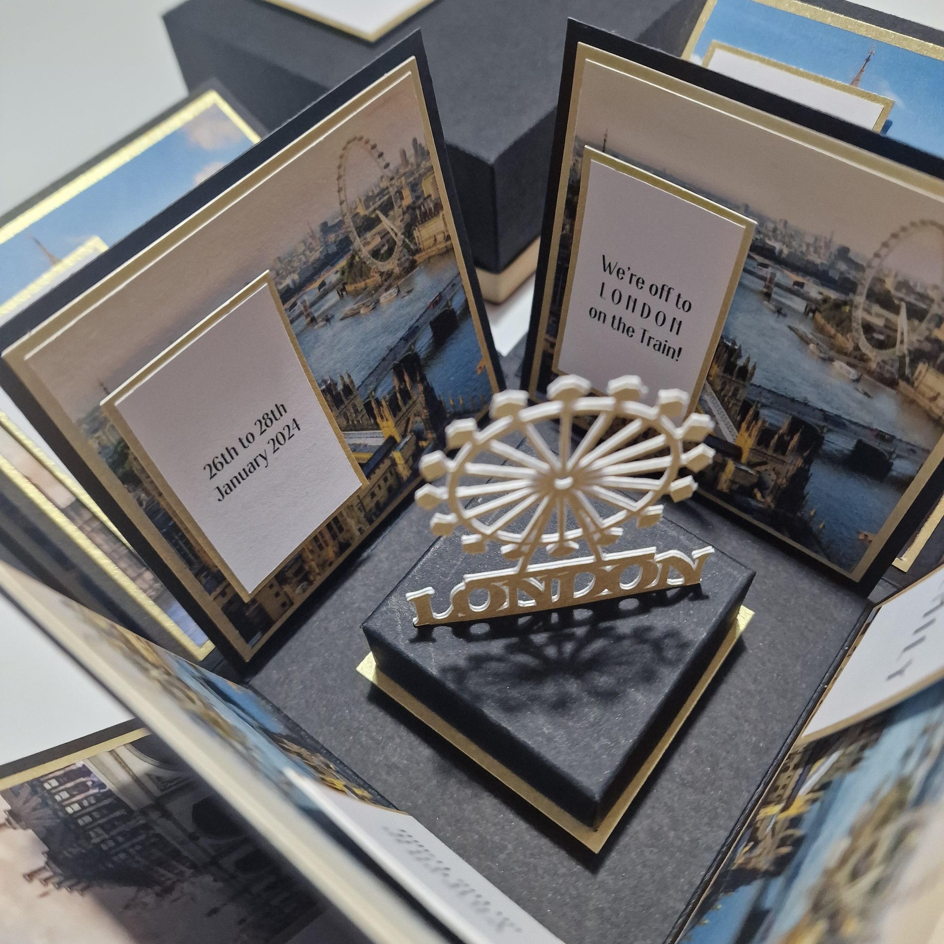 Exploding Occasions Box - Trip Reveal LONDON features a London-themed surprise box with cityscape and ferris wheel imagery, including freestanding London Eye and customizable panels for a special celebration.