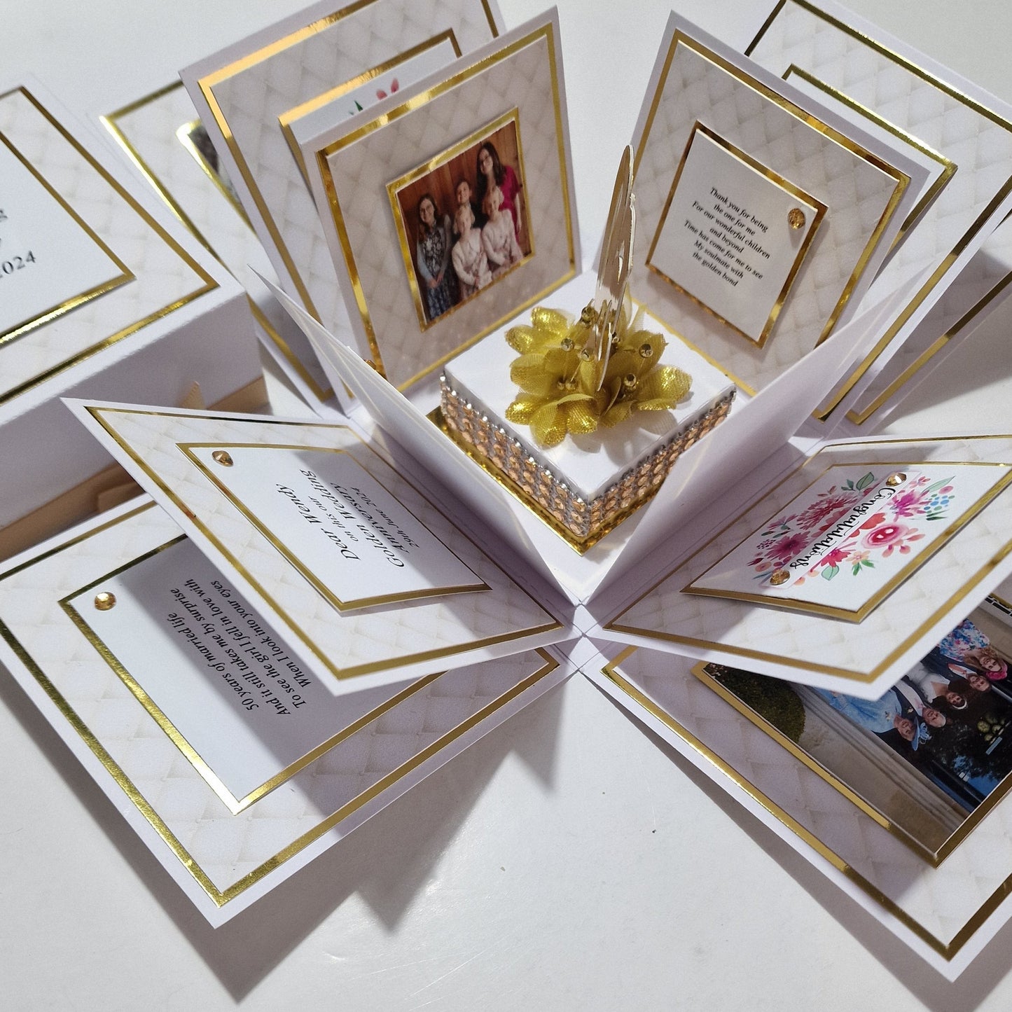 Golden Wedding Anniversary Exploding Box featuring a white exterior with gold floral accents. Includes customizable panels with family photos and messages, celebrating love and commitment.