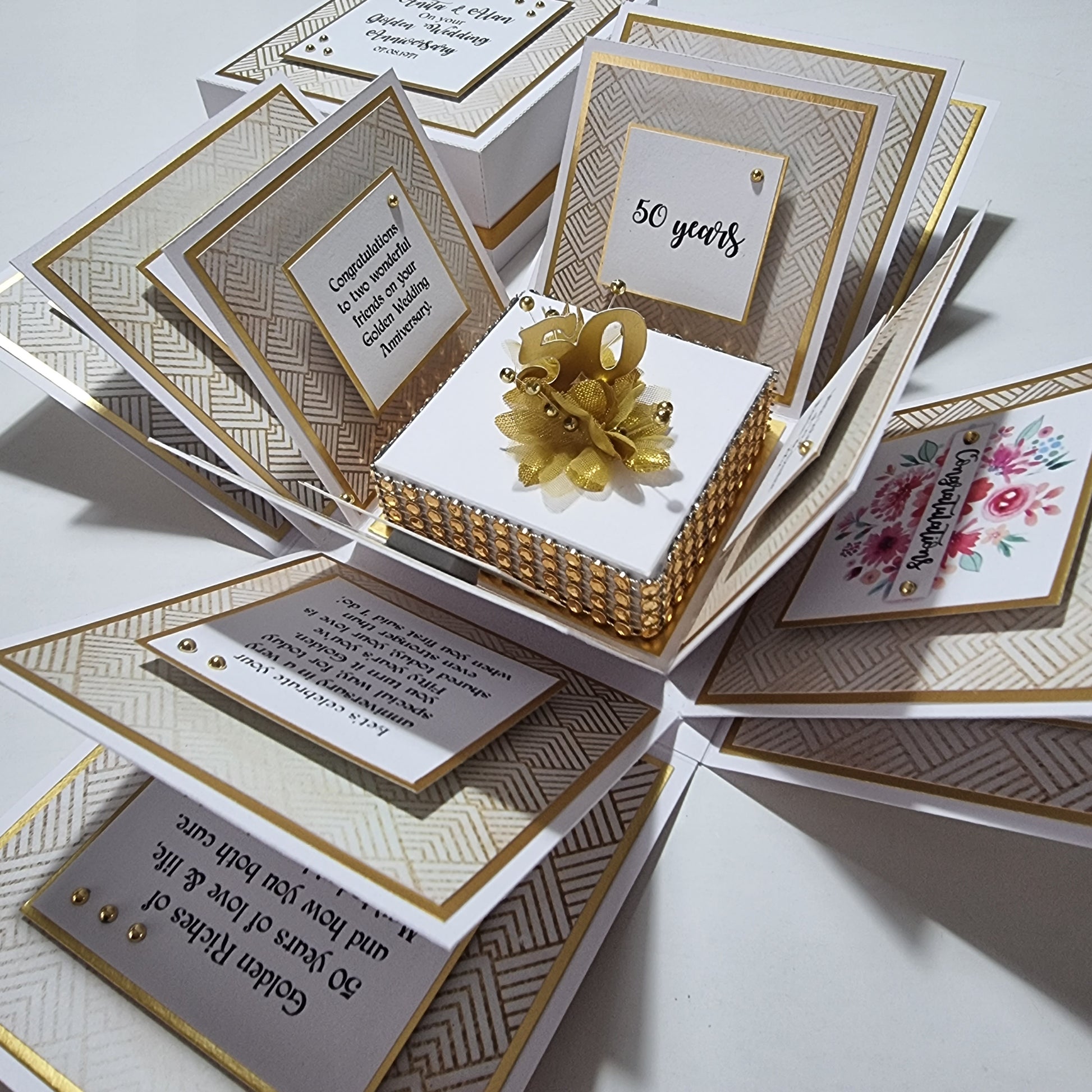 Golden Wedding Anniversary Exploding Box with gold accents, featuring a decorative gold bow and personalized details like couple's names and anniversary date, designed as a keepsake for celebrating 50 years of marriage.