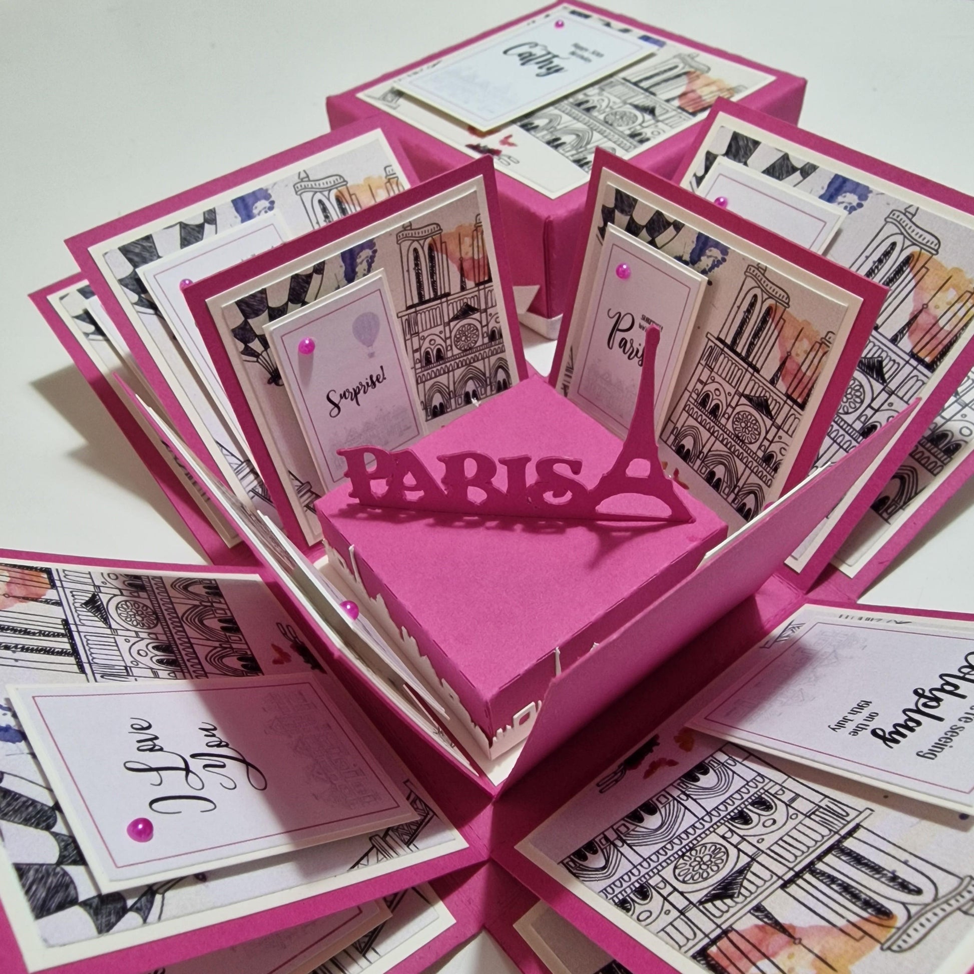 Exploding Occasions Box - Trip Reveal PARIS featuring Paris-themed paper panels, Eiffel Tower centerpiece, and personalized elements for a surprise trip reveal.