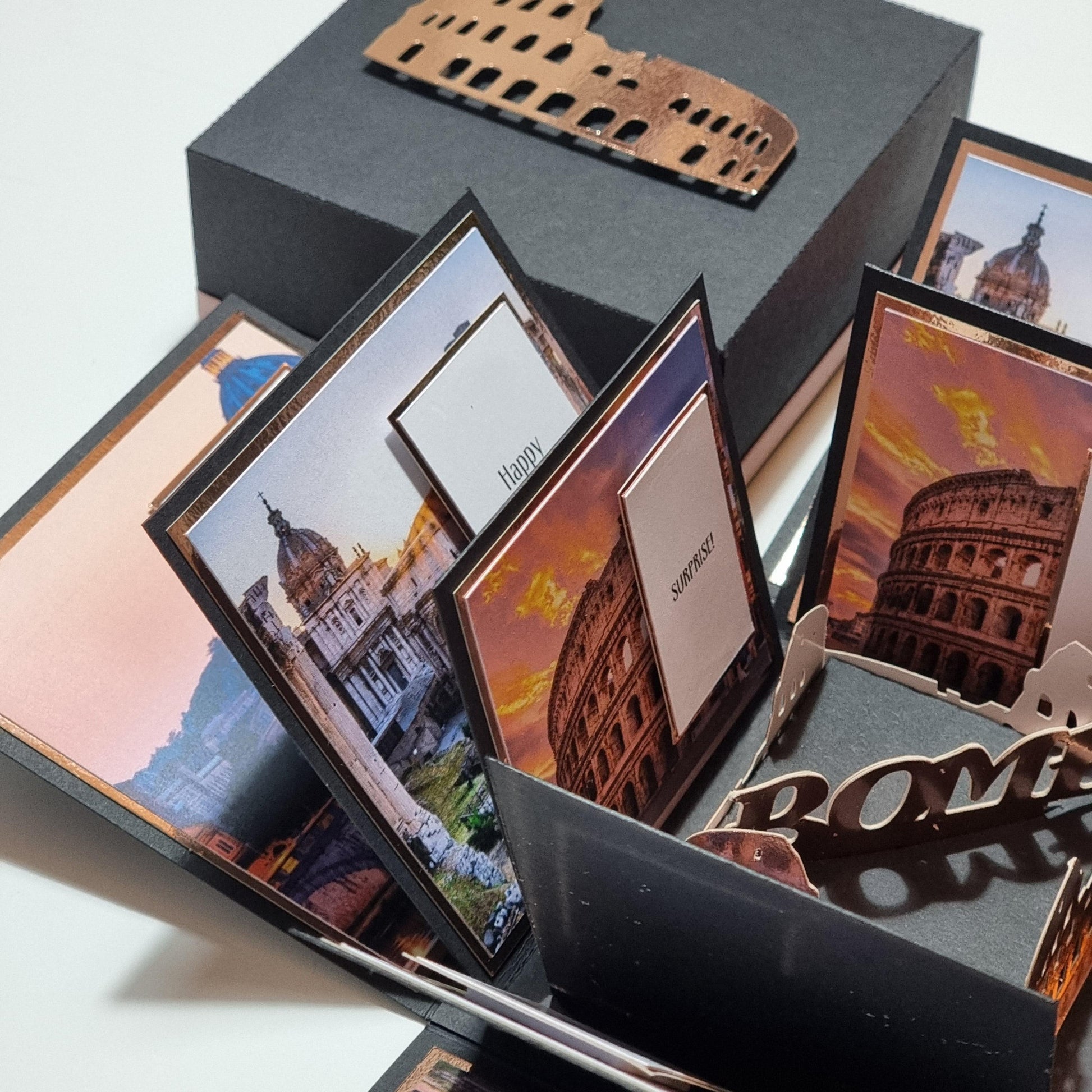 Exploding Occasions Box - Trip Reveal ROME featuring images of the Colosseum, picture frames, and cards, designed as a surprise trip reveal with landscape and event details included.