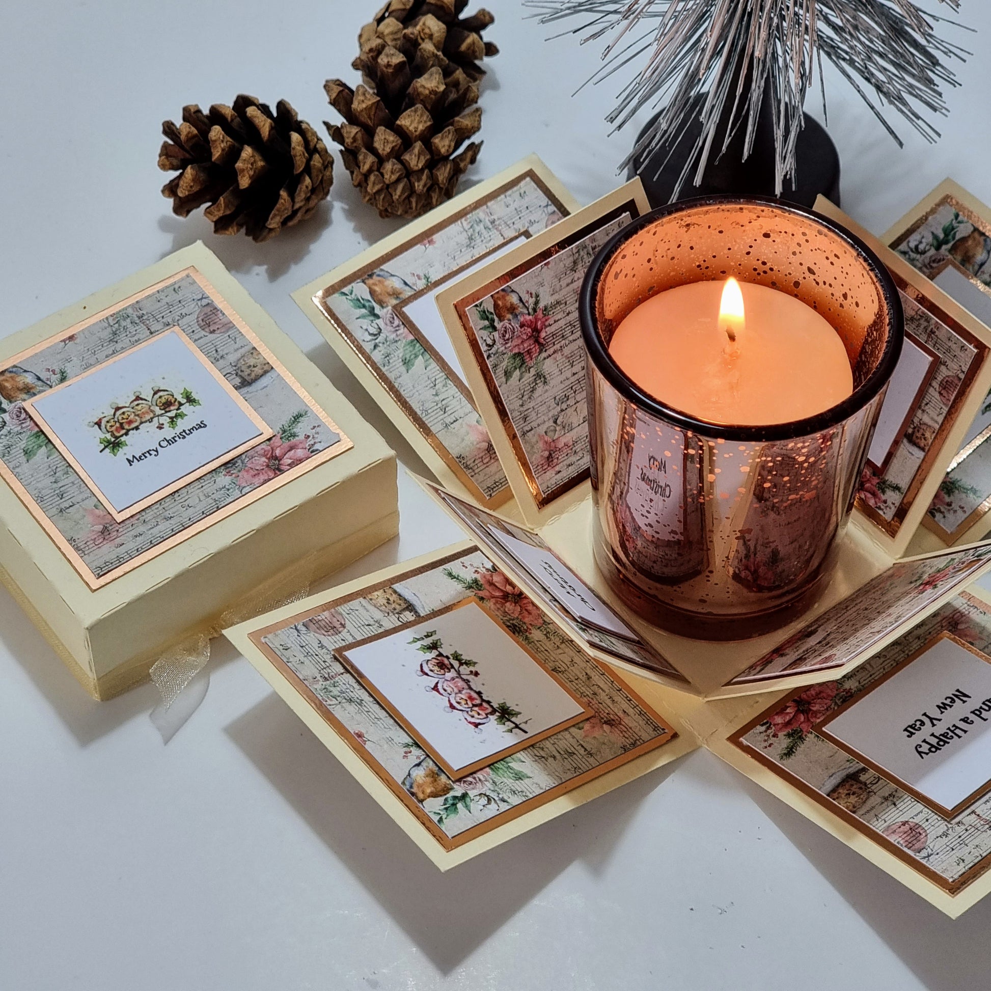 Cream box with christmas papers and Merry christmas greeting & Candle