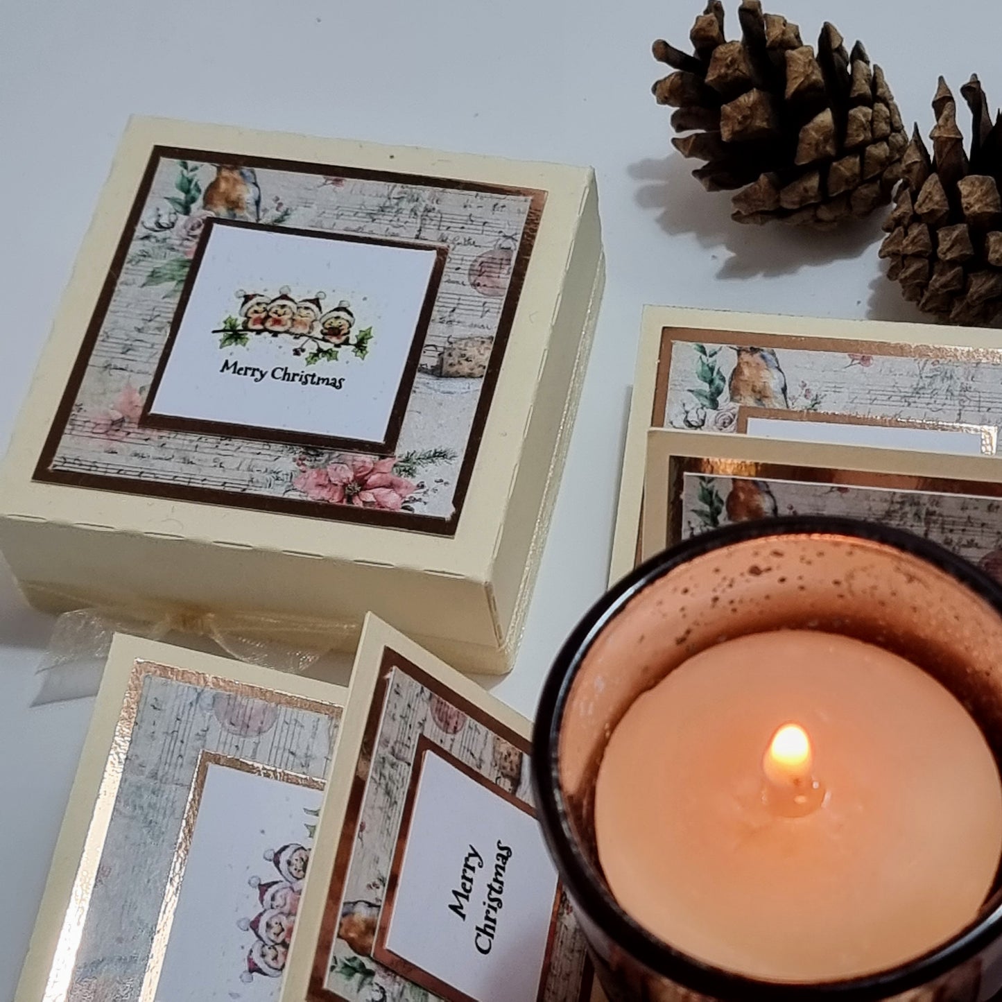 Cream box with christmas papers and Merry christmas greeting & Candle