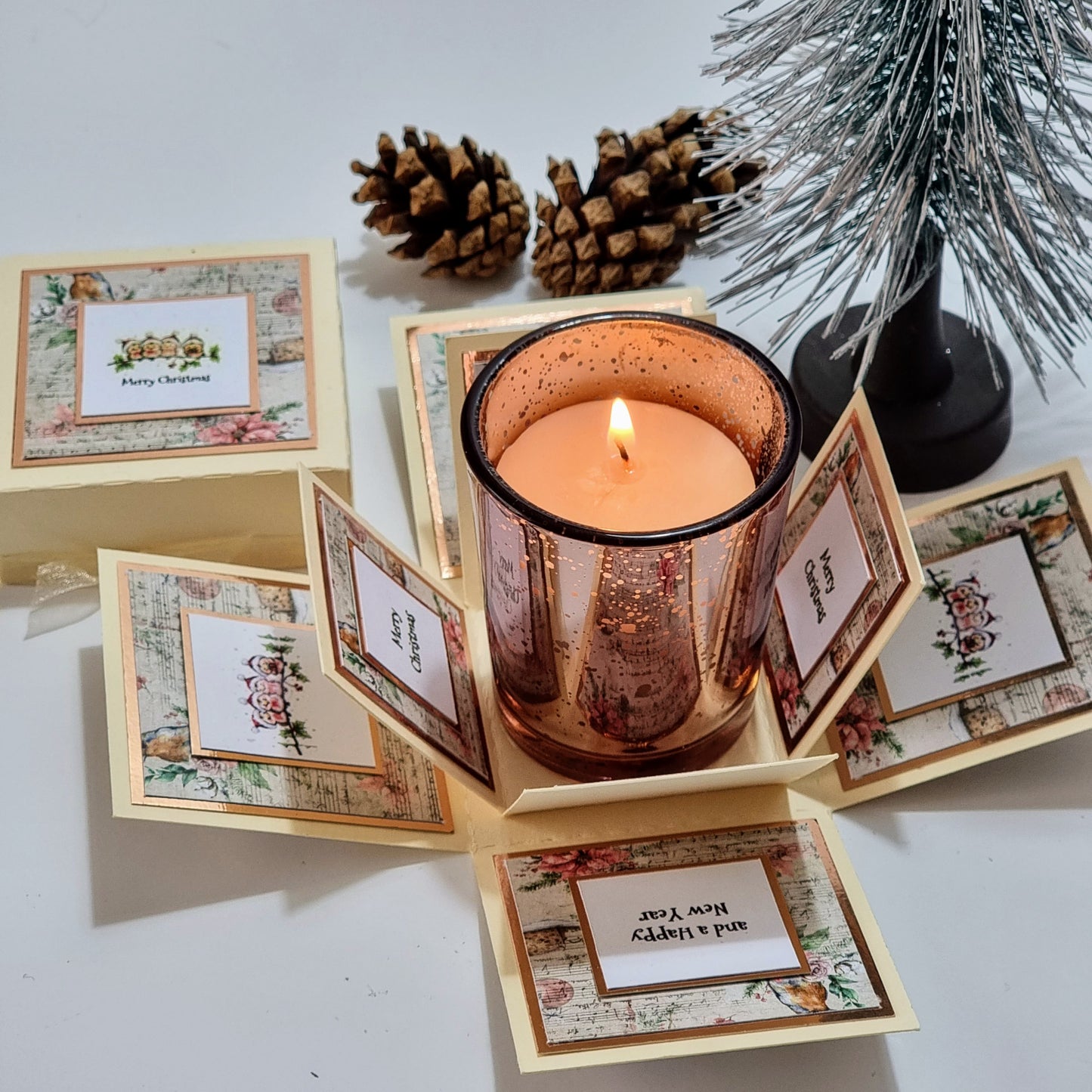 Cream box with christmas papers and Merry christmas greeting & Candle