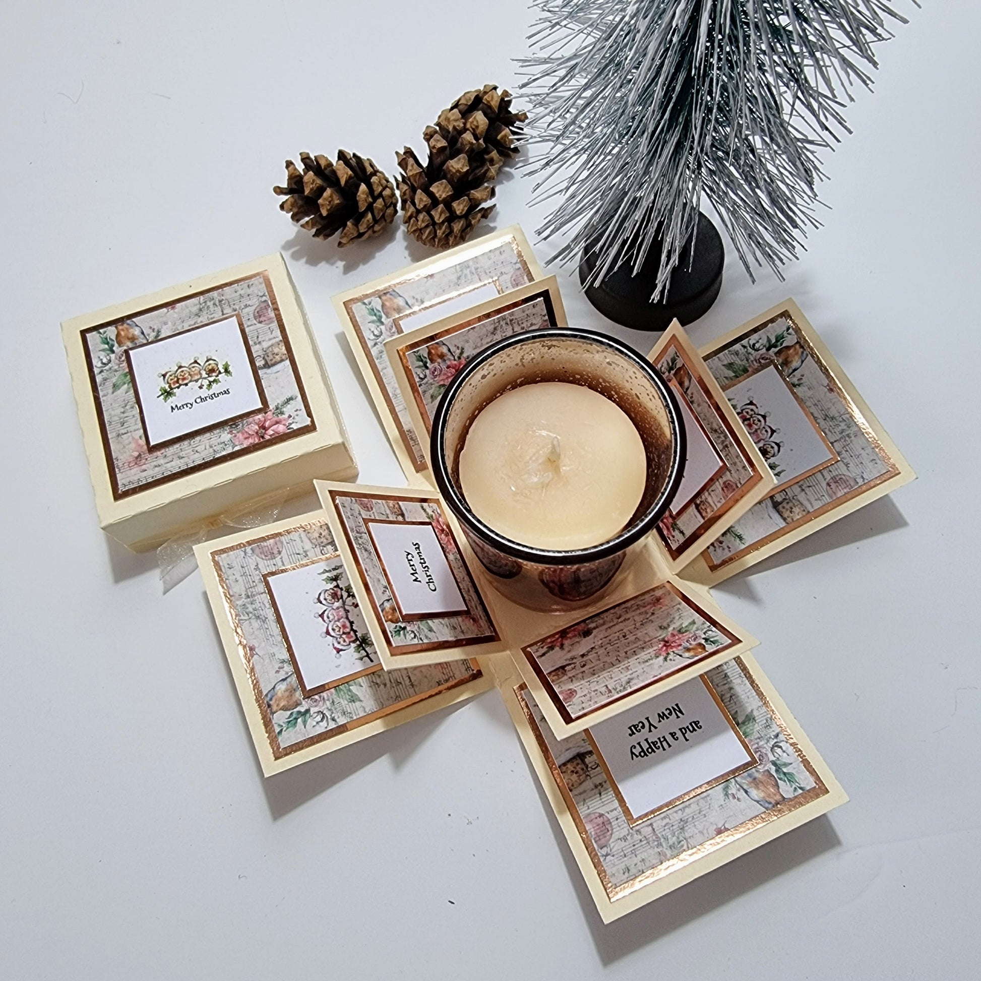 Cream box with christmas papers and Merry christmas greeting & Candle