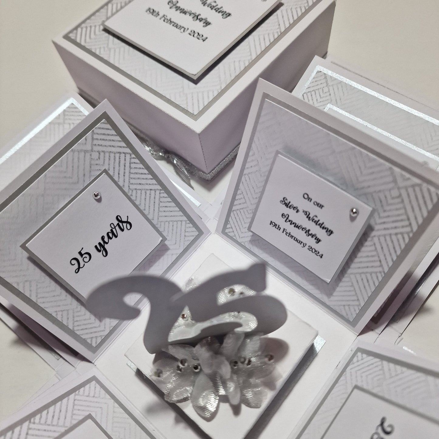 Silver Wedding Anniversary Box with elegant silver accents, featuring panels with heartfelt messages and customizable options for names, dates, and photos, providing a unique keepsake for celebrating 25th anniversaries.