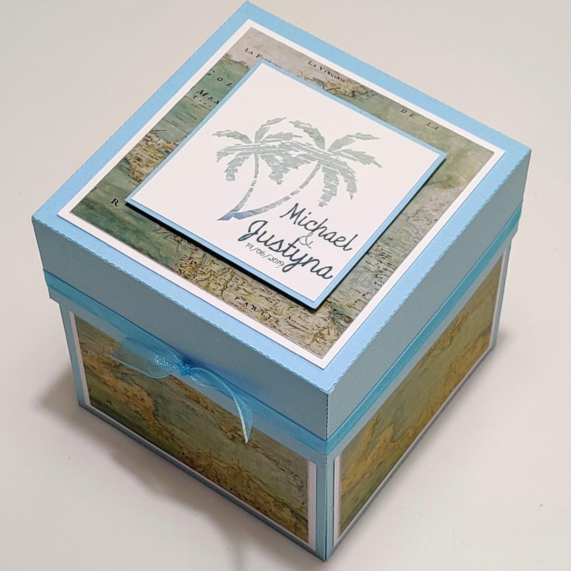 Travel Themed Proposal Box - Exploding Proposal - Ring Box features a blue box with a blue ribbon, white card, and map design, perfect for a memorable engagement proposal.