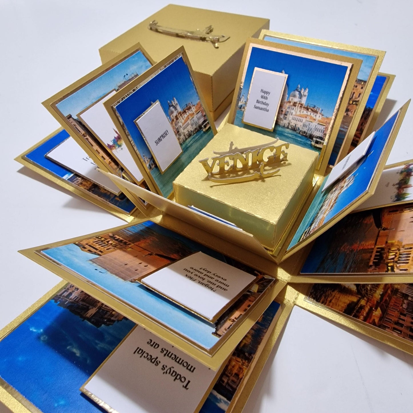 Exploding Occasions Box - Trip Reveal VENICE featuring iconic Venice architecture, gondola centerpiece, and paper panels. Designed for Venice-themed surprise trips, includes personalized details and excursion options.