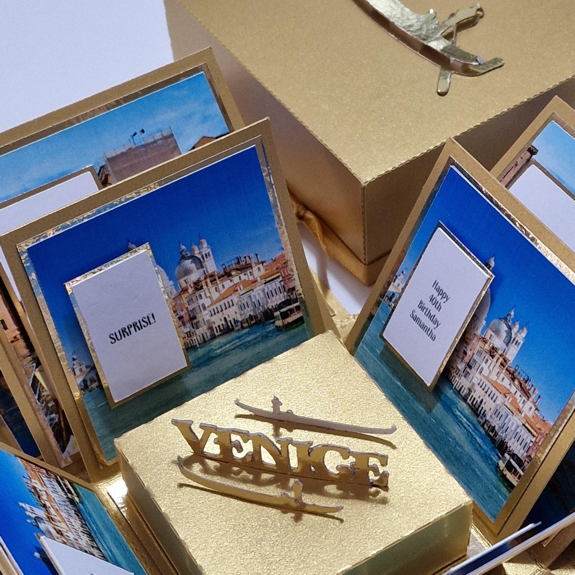 Exploding Occasions Box - Trip Reveal VENICE featuring city-themed panels, iconic architecture images, and a freestanding gondola, designed for a Venice surprise trip celebration.