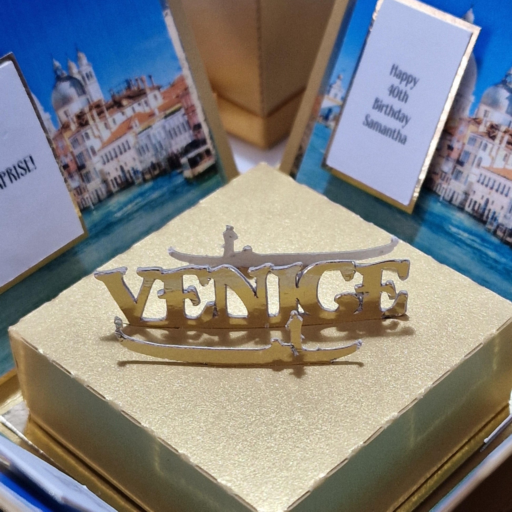 Exploding Occasions Box - Trip Reveal VENICE featuring a gold design with a gondola and iconic Venice architecture, personalized for a surprise trip celebration.