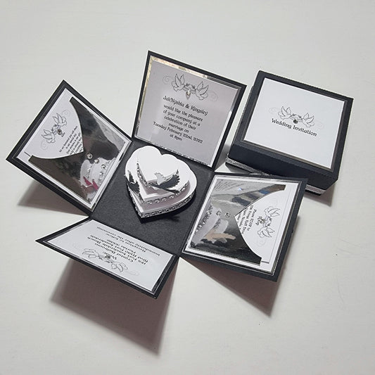 Black & Silver Exploding Wedding Invitation Box featuring a heart-shaped cake with doves, invitation details, and pull-out menu cards, perfectly capturing luxury invites and bespoke wedding stationery.