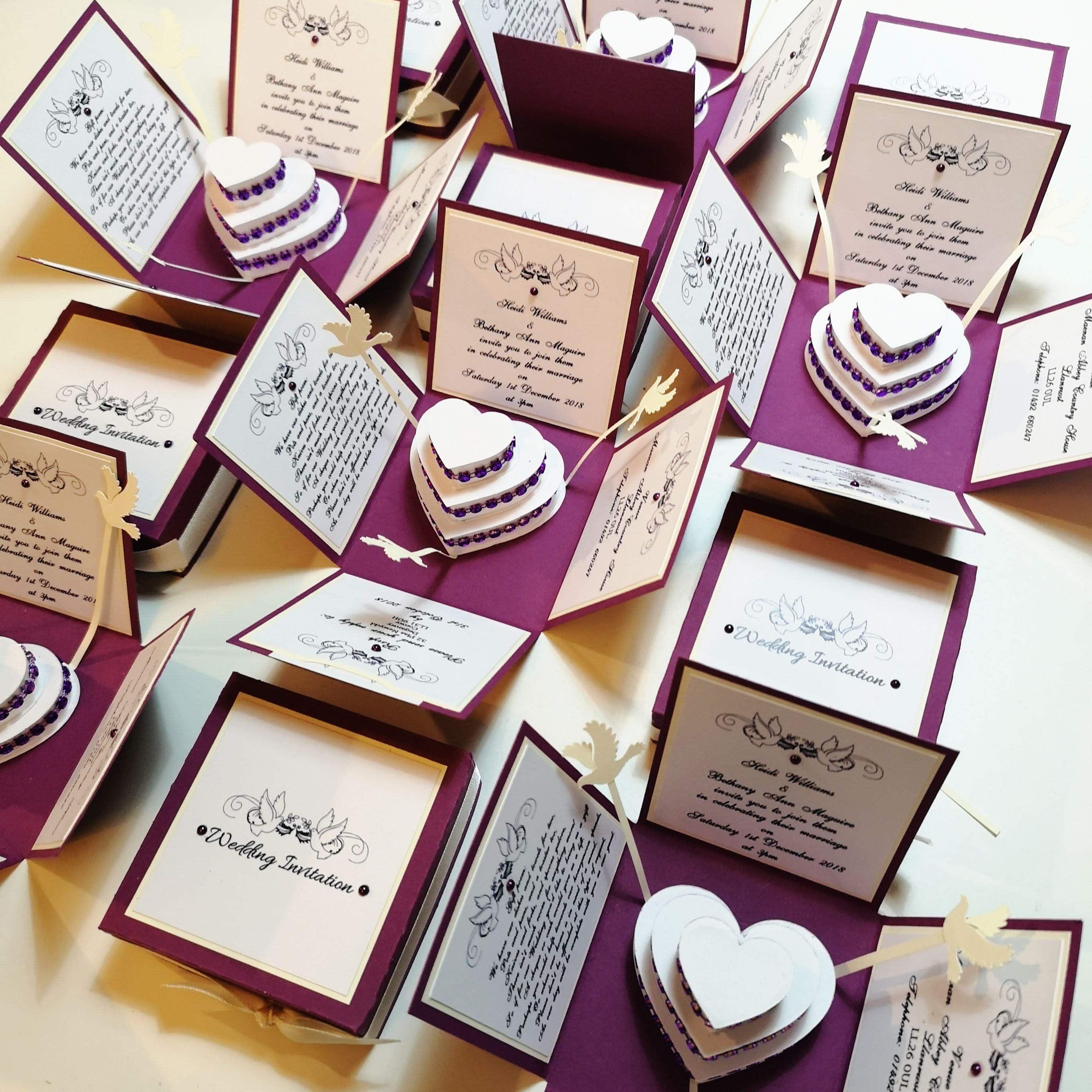 Purple & Cream Exploding Wedding Invitation Box featuring intricate doves and heart-shaped cake, with detailed invitation, menu, and RSVP cards inside. A luxurious bespoke stationery piece for special occasions.